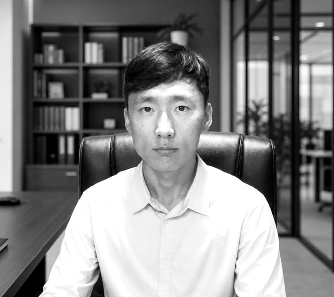 Daniel Lee at his desk, black and white portrait